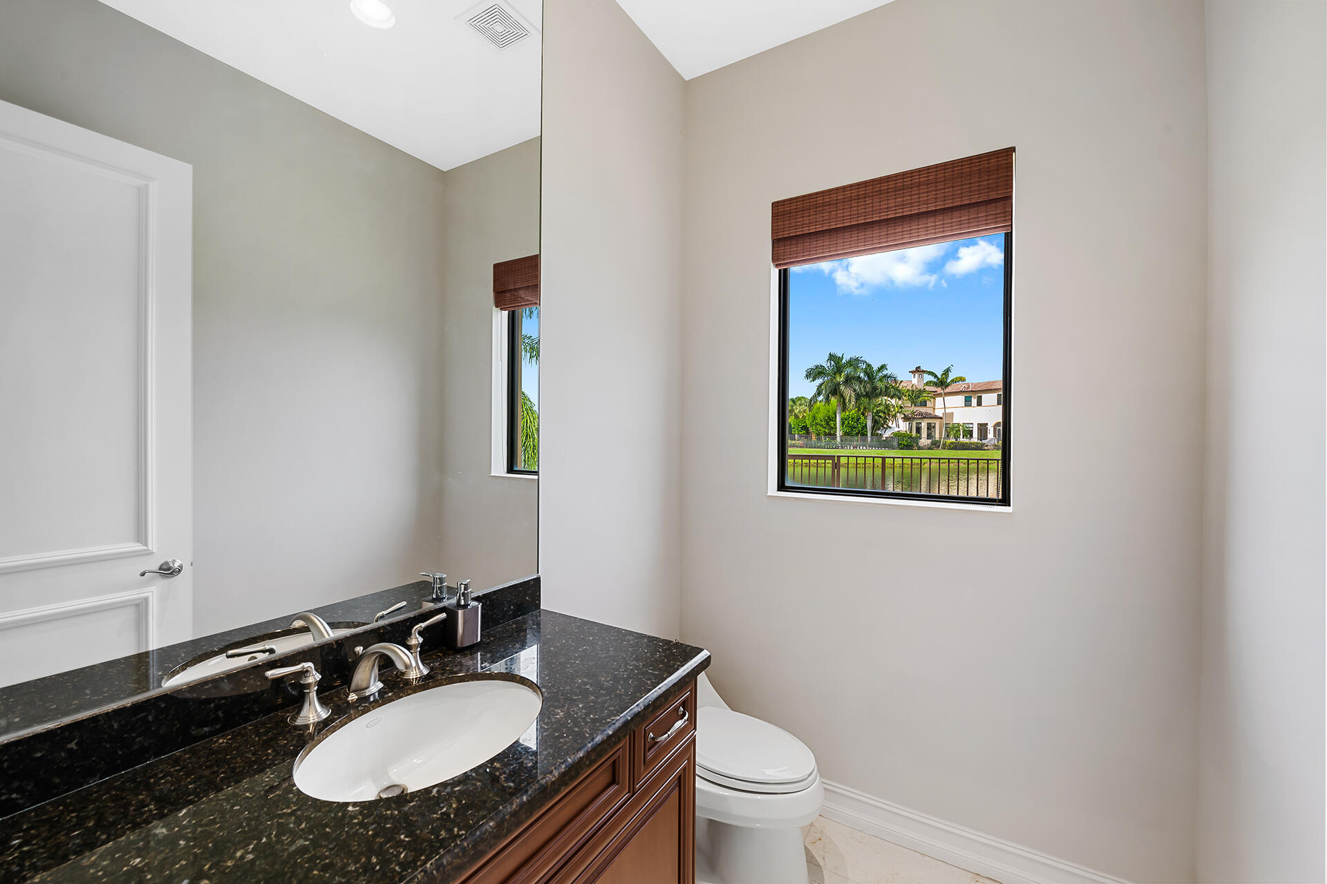 17895 Cadena Drive Boca Raton, FL 33496 - Photo 17 of 68 a bathroom with a granite countertop sink and a mirror