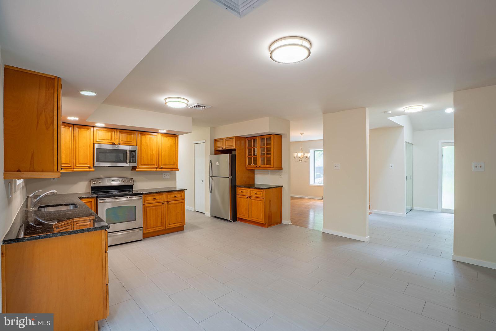 491 Kings Road Yardley, PA 19067 - Photo 15 of 52 a kitchen with stainless steel appliances kitchen island granite countertop a refrigerator and a stove