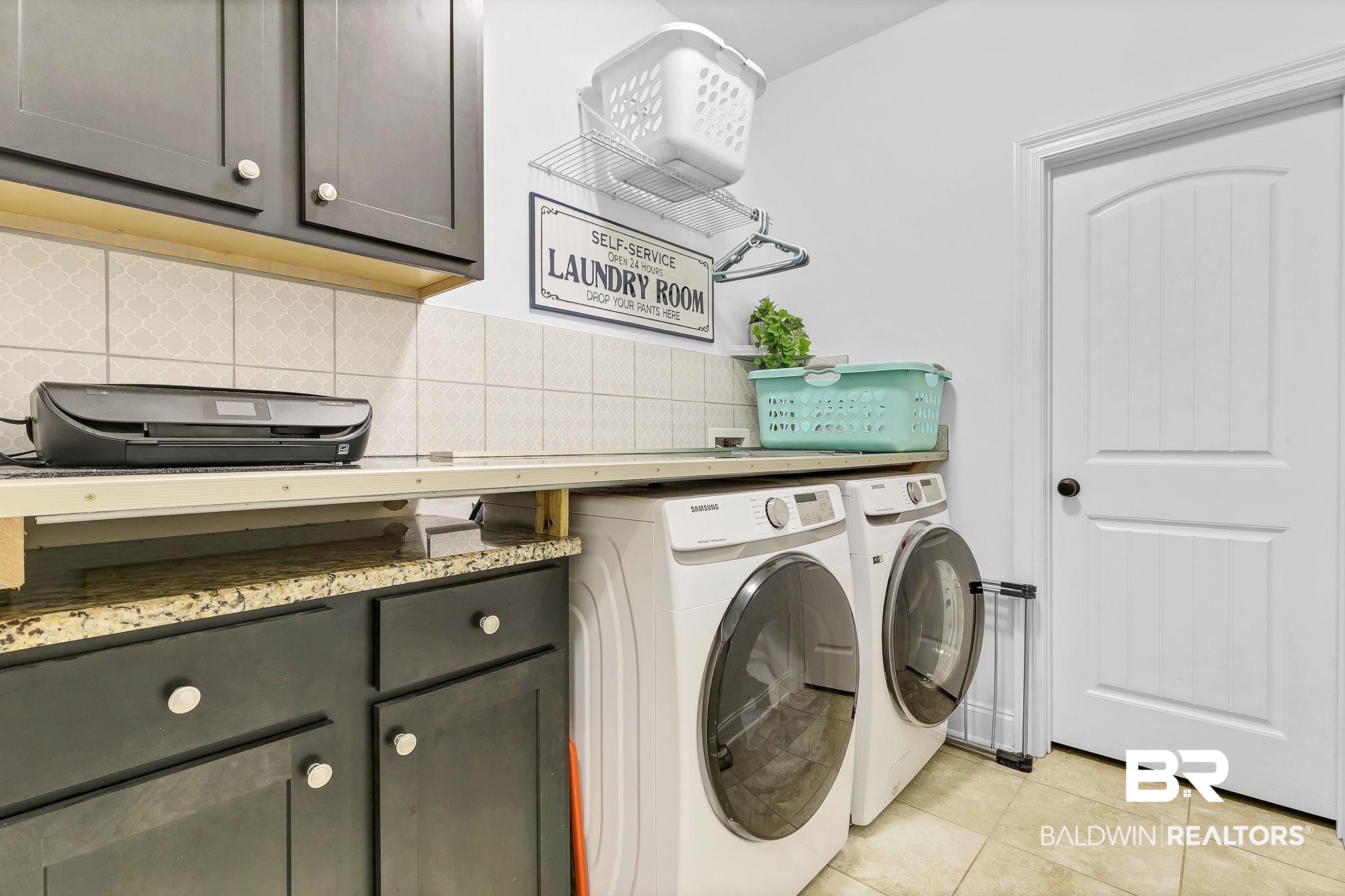 30635 Drayton Court Daphne, AL 36527 - Photo 32 of 51 Washroom with washing machine and clothes dryer, light tile patterned floors, and cabinet space