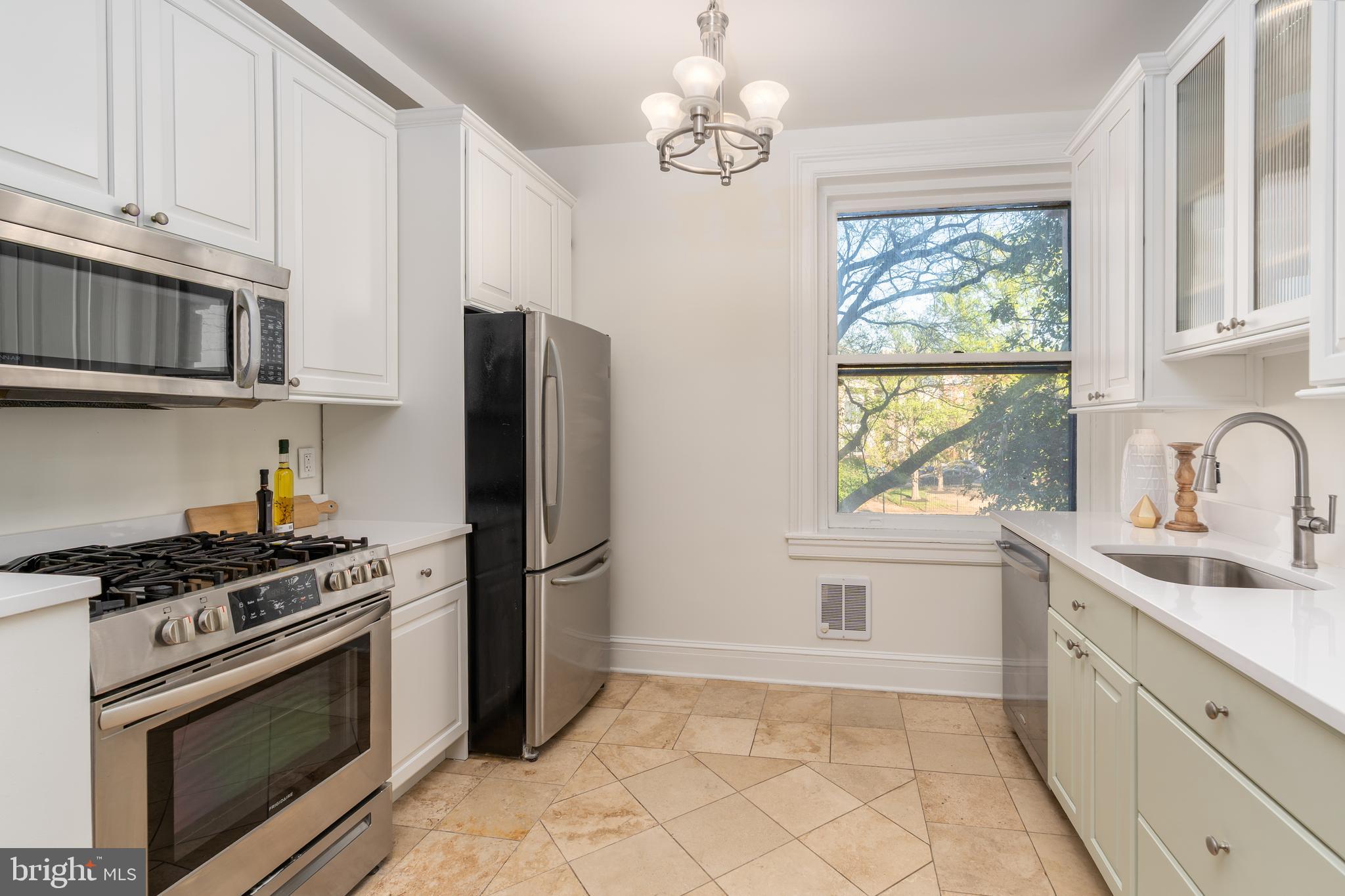 3060 16th Street Northwest, Unit 209 Washington, DC 20009 - Photo 13 of 33 a kitchen with stainless steel appliances granite countertop a sink stove and refrigerator