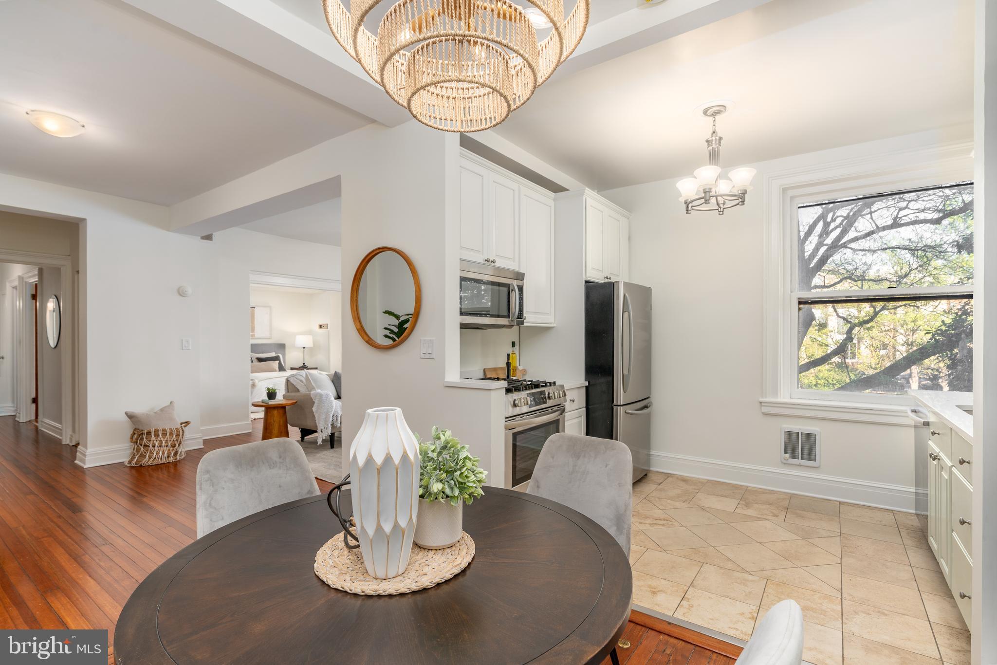 3060 16th Street Northwest, Unit 209 Washington, DC 20009 - Photo 14 of 33 a dining room with furniture a chandelier and wooden floor