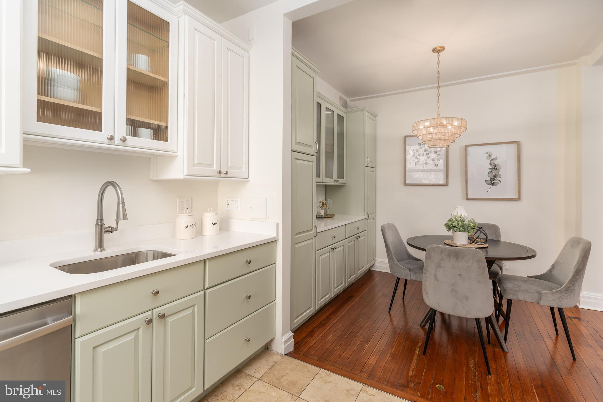 3060 16th Street Northwest, Unit 209 Washington, DC 20009 - Photo 15 of 33 a kitchen with stainless steel appliances a dining table chairs and wooden floor