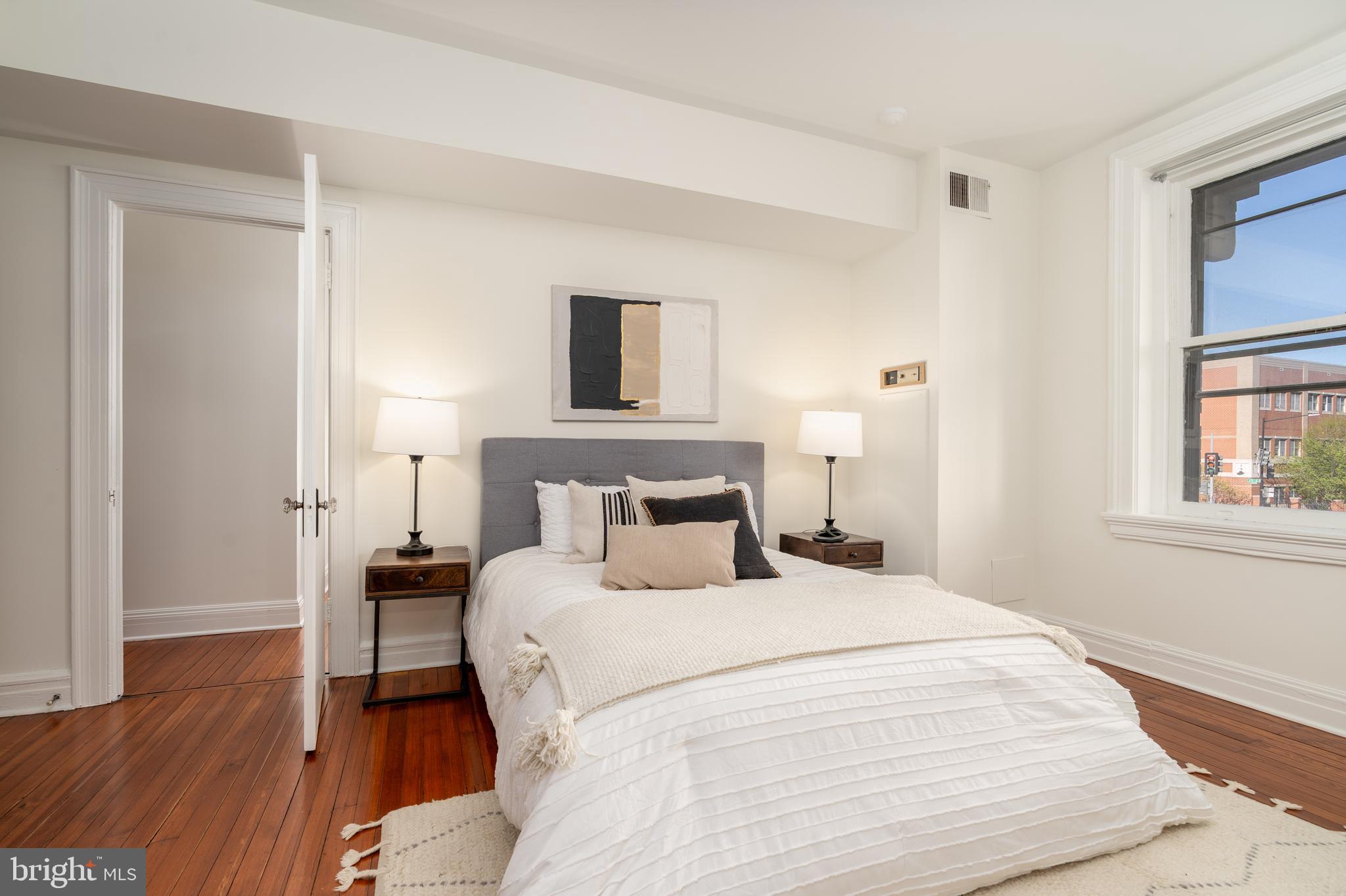 3060 16th Street Northwest, Unit 209 Washington, DC 20009 - Photo 18 of 33 a bedroom with a bed and a window