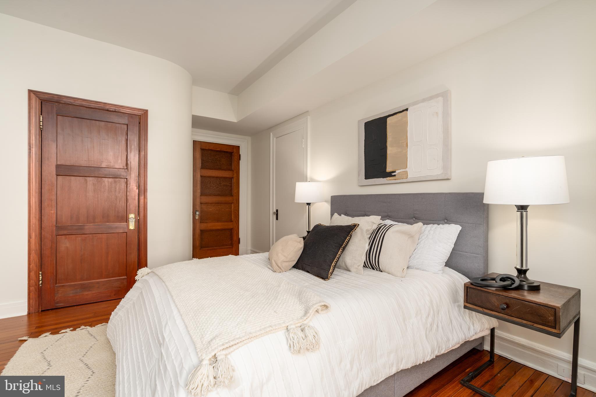 3060 16th Street Northwest, Unit 209 Washington, DC 20009 - Photo 19 of 33 a bedroom with a bed and a lamp on table