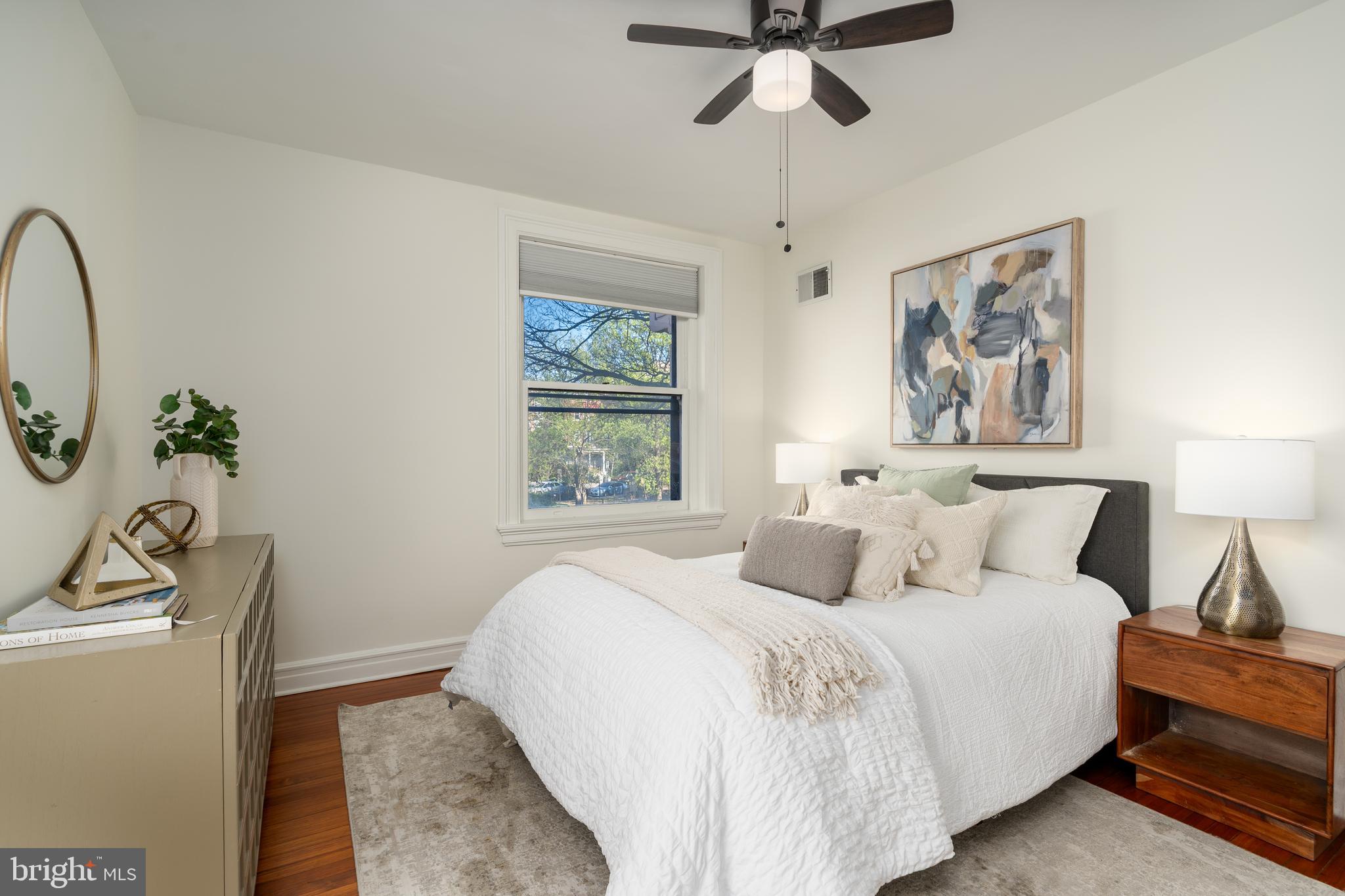 3060 16th Street Northwest, Unit 209 Washington, DC 20009 - Photo 21 of 33 a bedroom with a bed and a chandelier