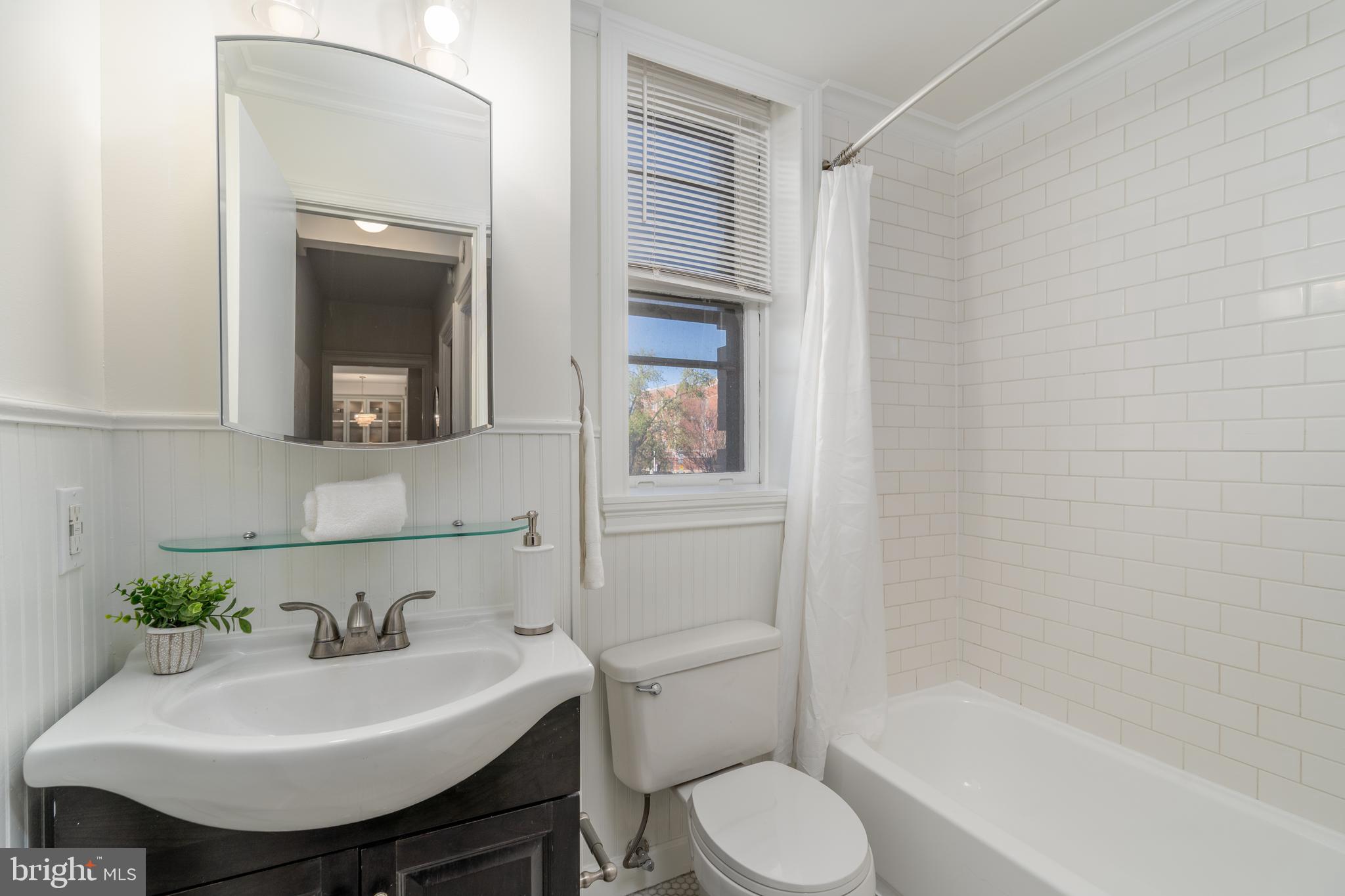 3060 16th Street Northwest, Unit 209 Washington, DC 20009 - Photo 22 of 33 a bathroom with a sink toilet and shower