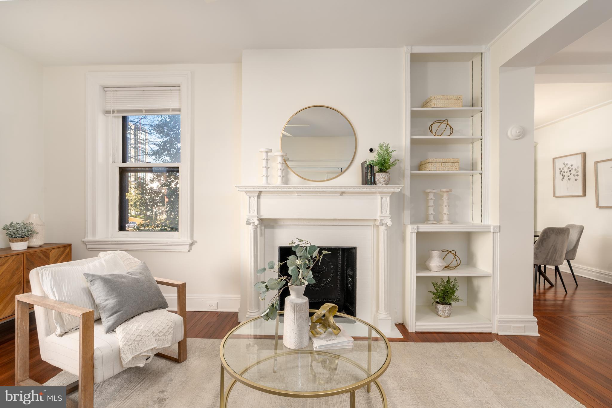 3060 16th Street Northwest, Unit 209 Washington, DC 20009 - Photo 4 of 33 a living room with furniture a window and a fireplace