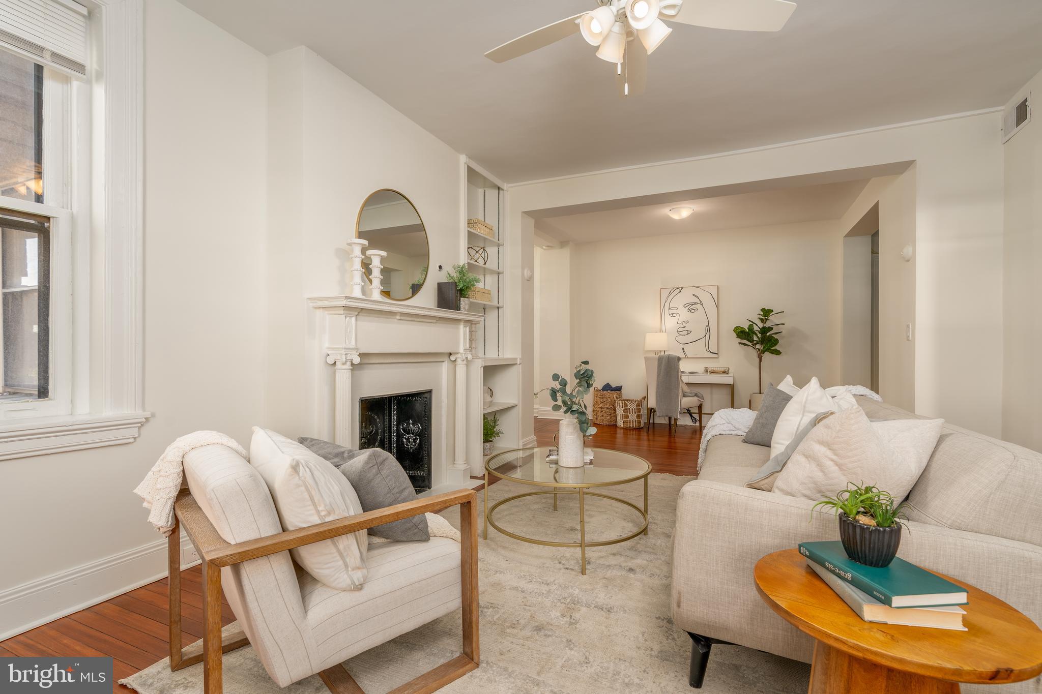 3060 16th Street Northwest, Unit 209 Washington, DC 20009 - Photo 7 of 33 a living room with furniture a fireplace and a chandelier