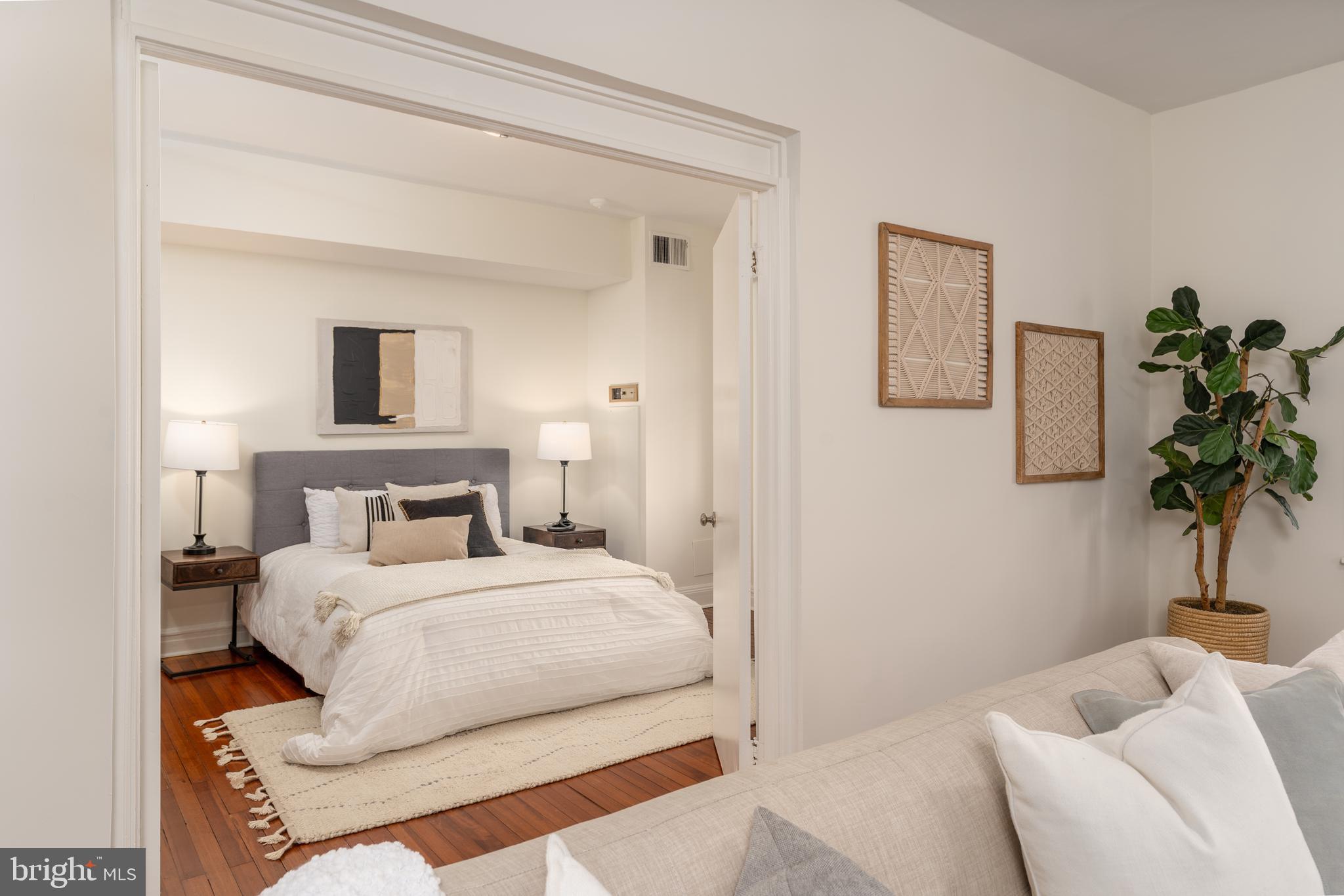 3060 16th Street Northwest, Unit 209 Washington, DC 20009 - Photo 8 of 33 a bedroom with a bed and a potted plant