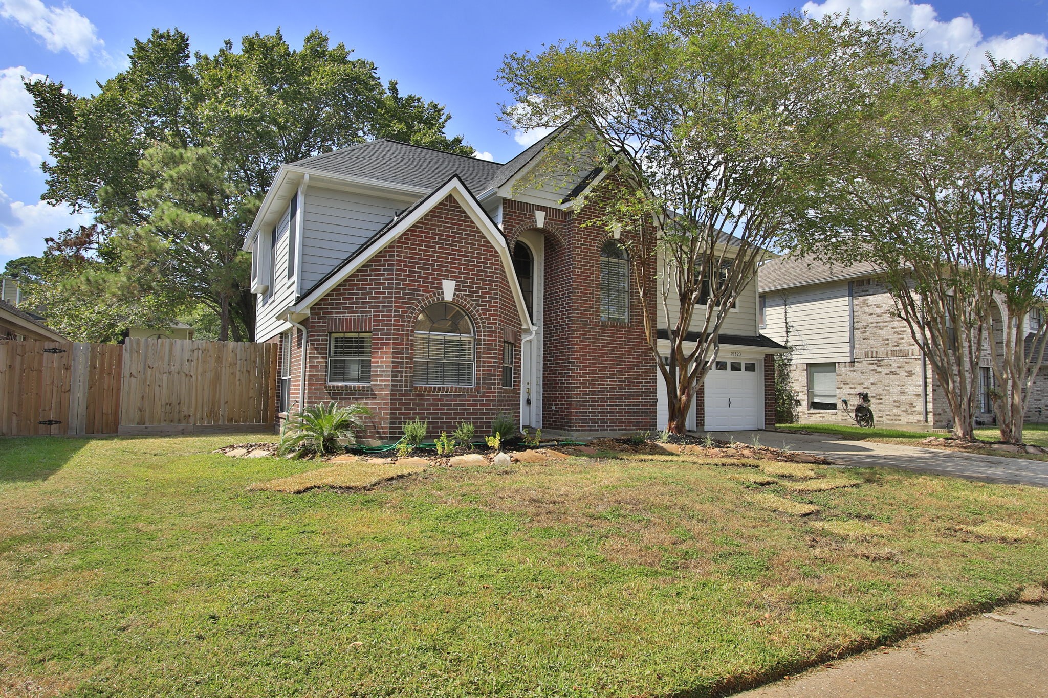 a backyard of a house with table and chairs