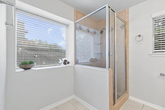 a bathroom with a shower and a window