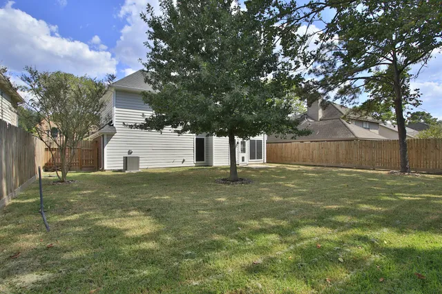 a backyard of a house with table and chairs