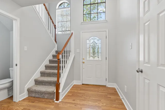a view of an entryway with wooden floor