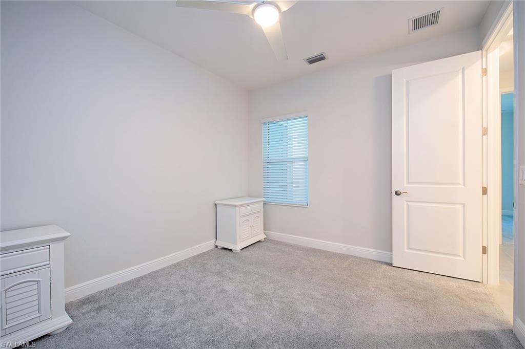 2409 Ariane Drive Naples, FL 34112 - Photo 13 of 16 a view of a livingroom with an empty space and a window