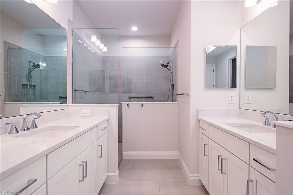 2409 Ariane Drive Naples, FL 34112 - Photo 16 of 16 a bathroom with a sink and a mirror