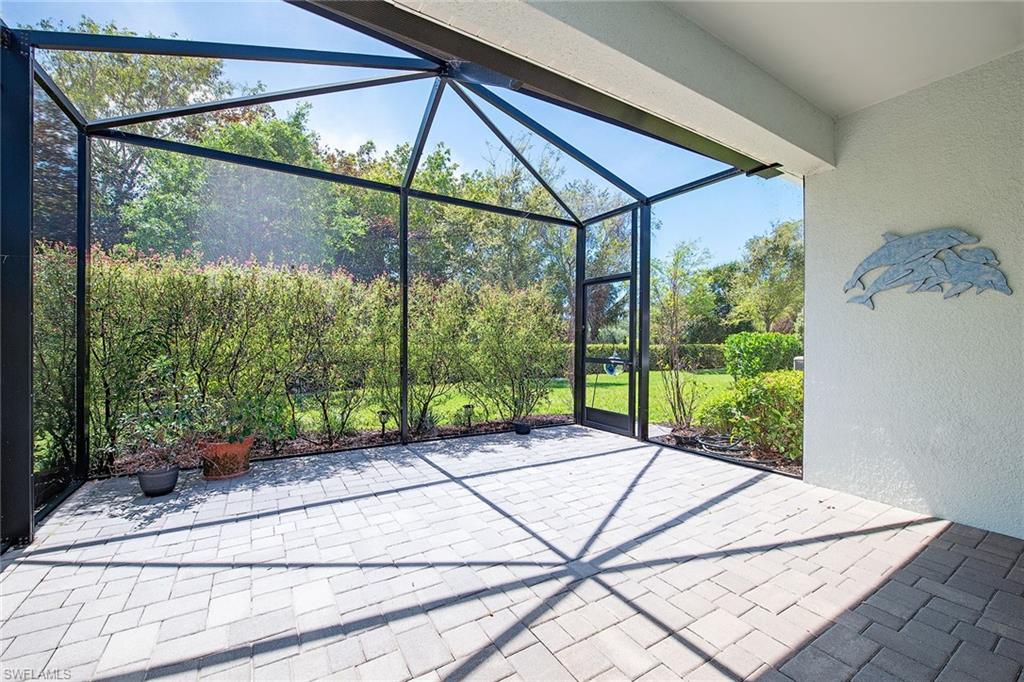 2409 Ariane Drive Naples, FL 34112 - Photo 2 of 16 a view of a porch with a floor to ceiling windows with yard in front of it