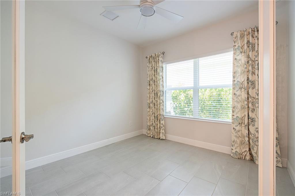 2409 Ariane Drive Naples, FL 34112 - Photo 10 of 16 a view of an empty room with a window