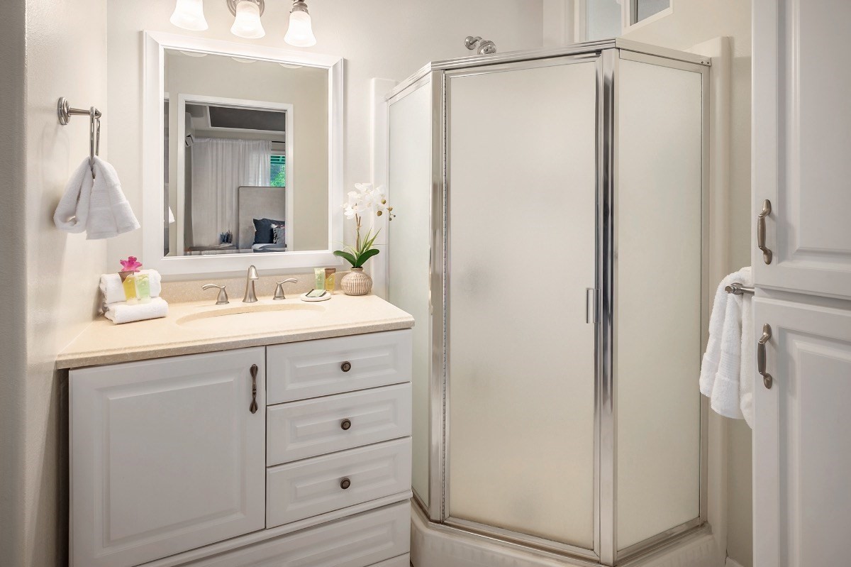2258 Kuai Road Koloa, HI 96756 - Photo 12 of 30 a bathroom with a sink a mirror a vanity and a shower