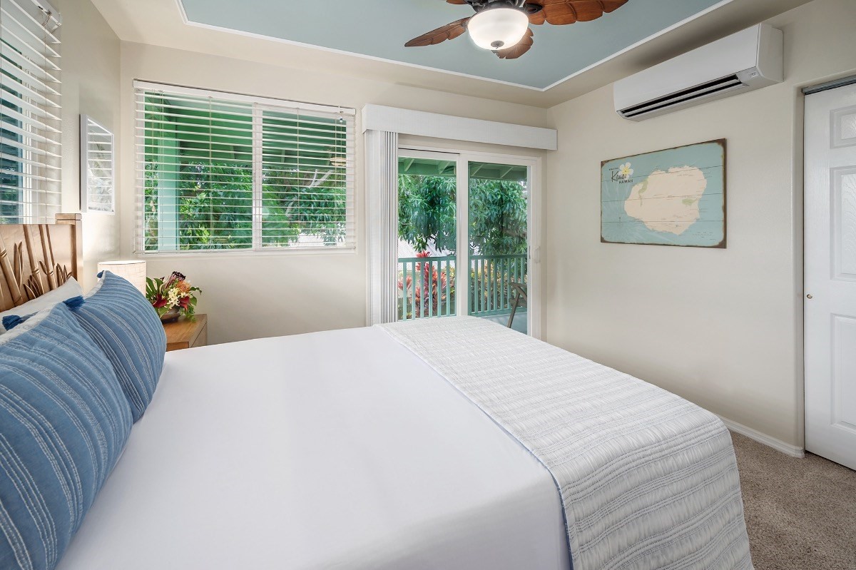 2258 Kuai Road Koloa, HI 96756 - Photo 14 of 30 a bed sitting in a bedroom next to a window