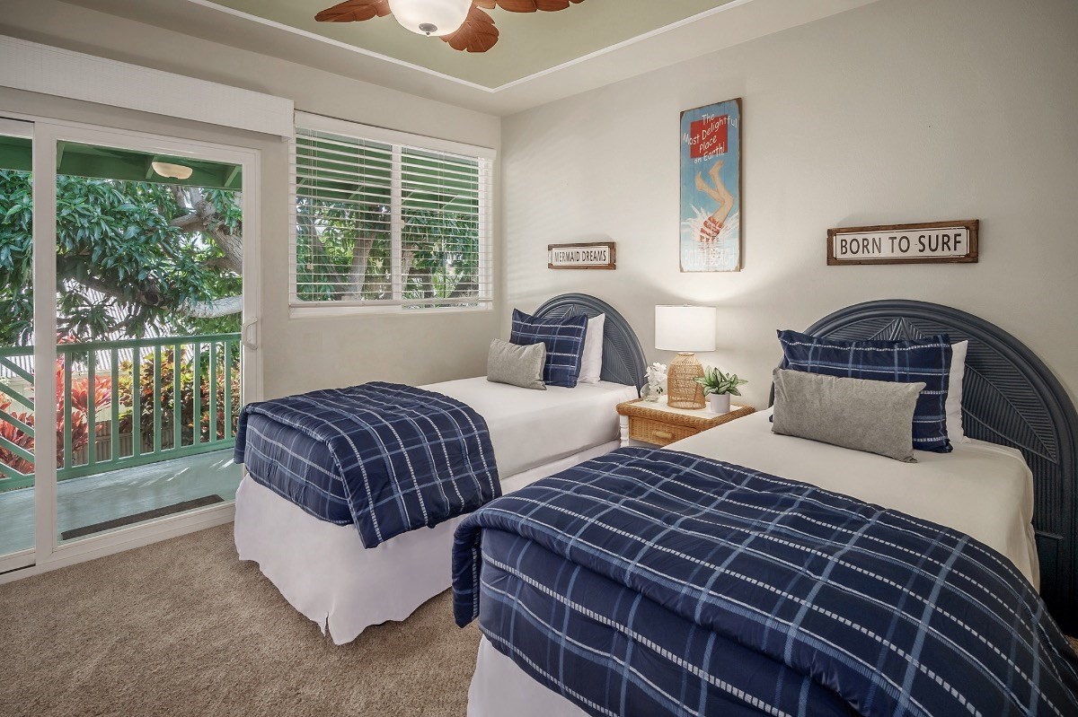 2258 Kuai Road Koloa, HI 96756 - Photo 17 of 30 a bedroom with two beds and large windows