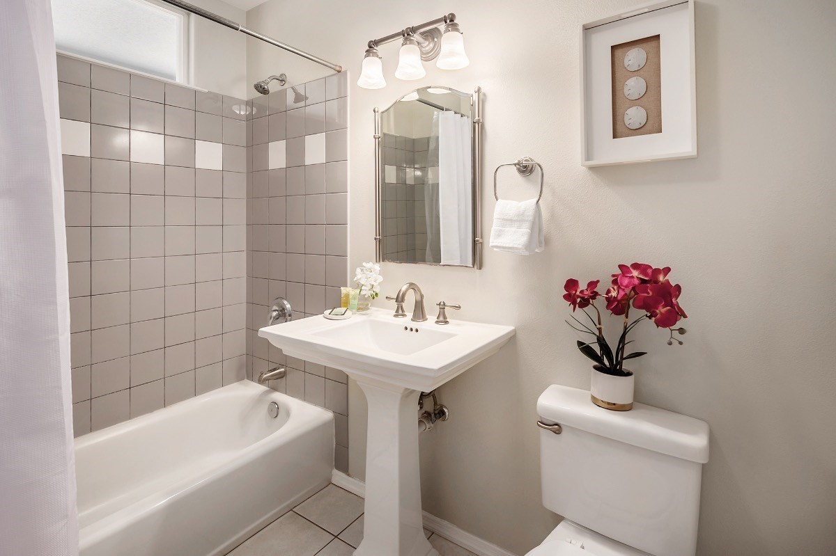 2258 Kuai Road Koloa, HI 96756 - Photo 19 of 30 a bathroom with a sink a tub and a mirror