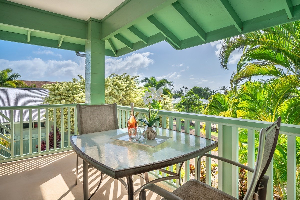 2258 Kuai Road Koloa, HI 96756 - Photo 24 of 30 a balcony with wooden floor table and chairs