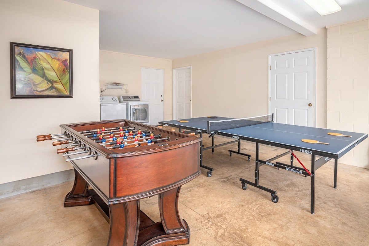 2258 Kuai Road Koloa, HI 96756 - Photo 25 of 30 a living room with a table and paintings on the wall