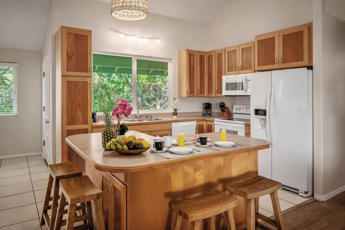 2258 Kuai Road Koloa, HI 96756 - Photo 6 of 30 a kitchen with a dining table chairs and window