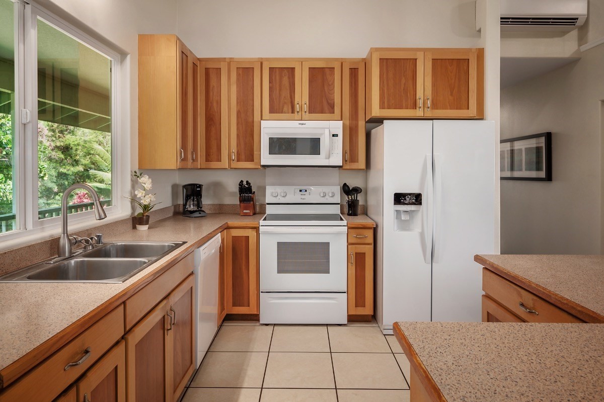 2258 Kuai Road Koloa, HI 96756 - Photo 7 of 30 a kitchen with a sink stove and refrigerator