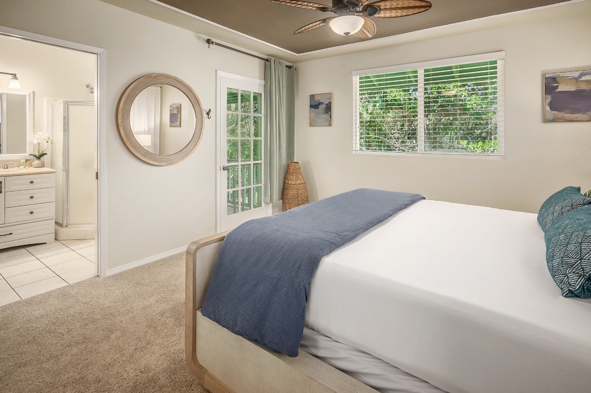 2258 Kuai Road Koloa, HI 96756 - Photo 10 of 30 a bedroom with a bed a mirror and a window