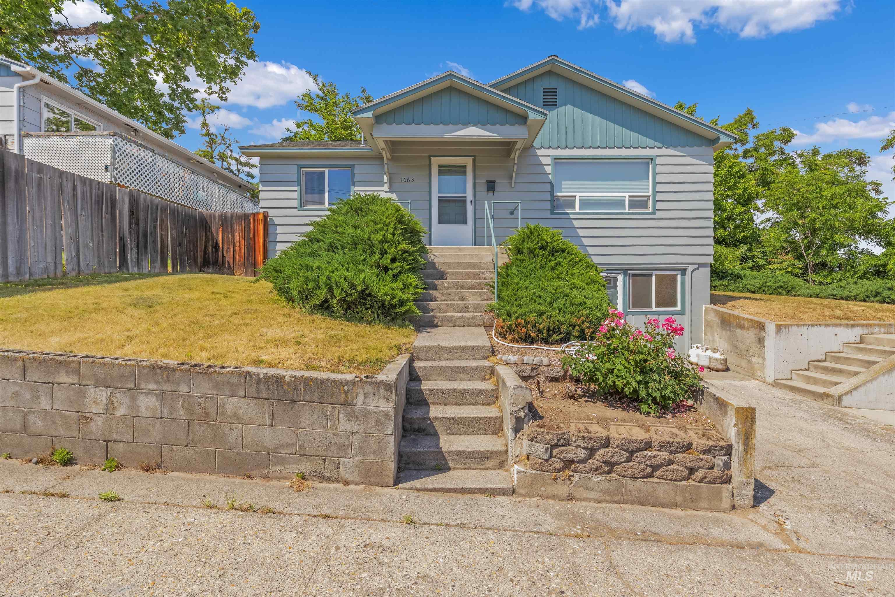 1663 9th Avenue Lewiston, ID 83501 - Photo 1 of 36 Split-level residence featuring gray siding and light blue trim accents