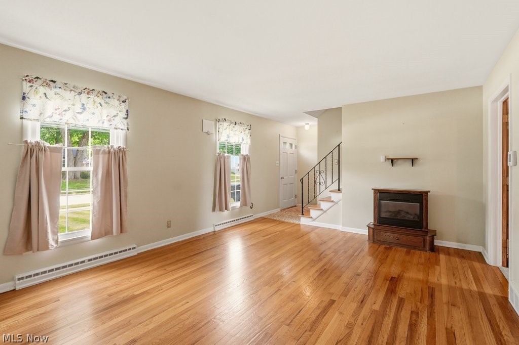 161 Pinehurst Road Munroe Falls, OH 44262 - Photo 7 of 40 Hardwood flooring extends throughout this room, featuring light-toned walls and multiple windows