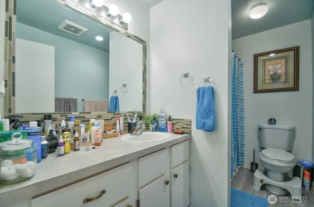 a bathroom with a double vanity sink and a mirror