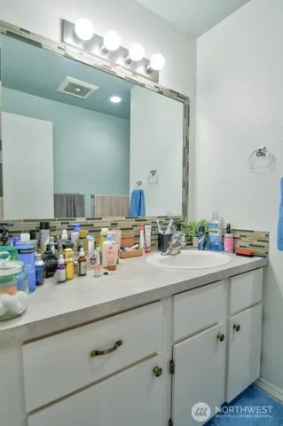 a bathroom with a sink double vanity and a mirror