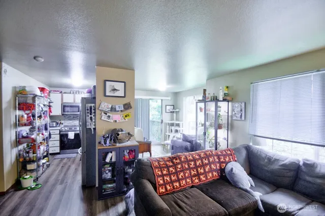 a living room with lots of furniture and wooden floor