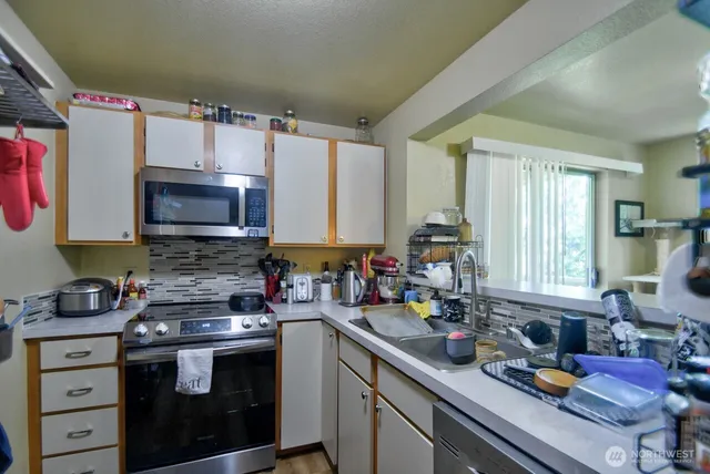 a kitchen with a sink stove and microwave