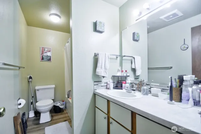 a bathroom with a sink toilet and mirror