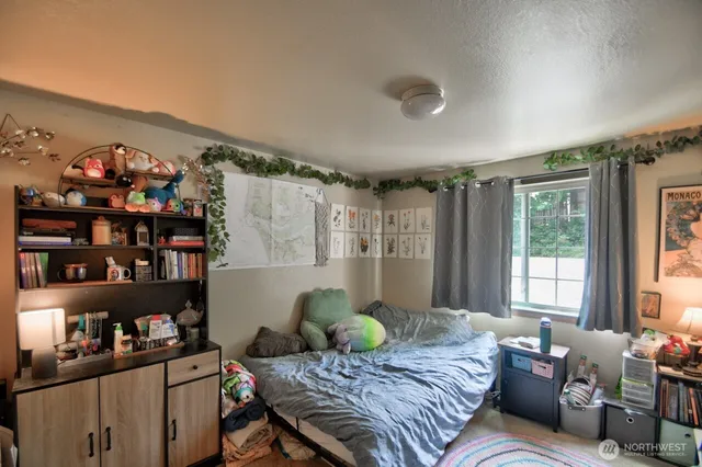 a bedroom with bed and a window