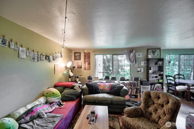 a living room with furniture toys and a large window