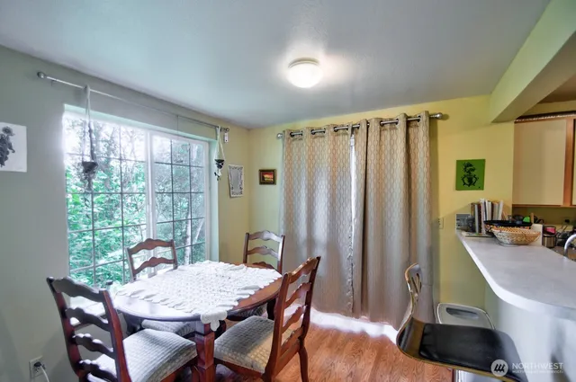 a view of a dining room with furniture window and outside view