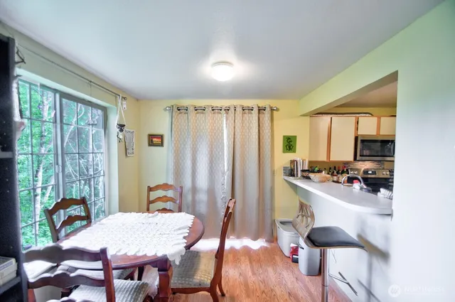 a view of a a dining room with furniture window and outside view
