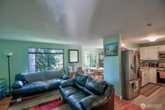 a living room with a couch and a refrigerator