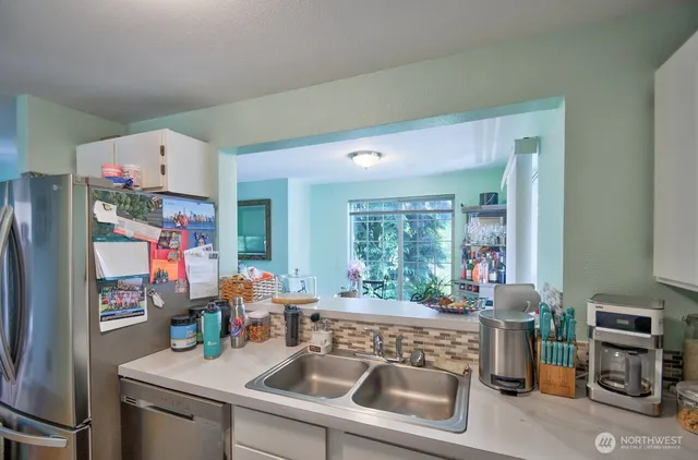a kitchen with a refrigerator and a stove