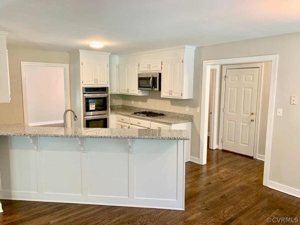 8301 Cattail Road Chesterfield, VA 23838 - Photo 11 of 31 a kitchen with stainless steel appliances a stove top oven and a refrigerator