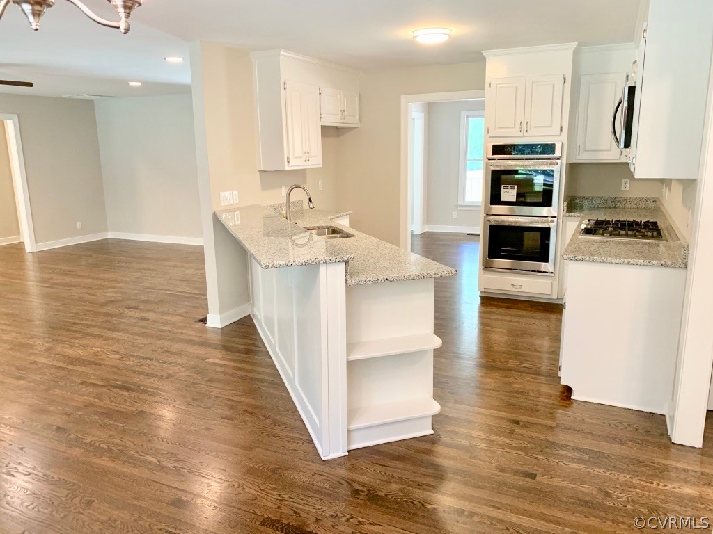 8301 Cattail Road Chesterfield, VA 23838 - Photo 12 of 31 a kitchen with stainless steel appliances granite countertop a sink a stove top oven a counter space and cabinets