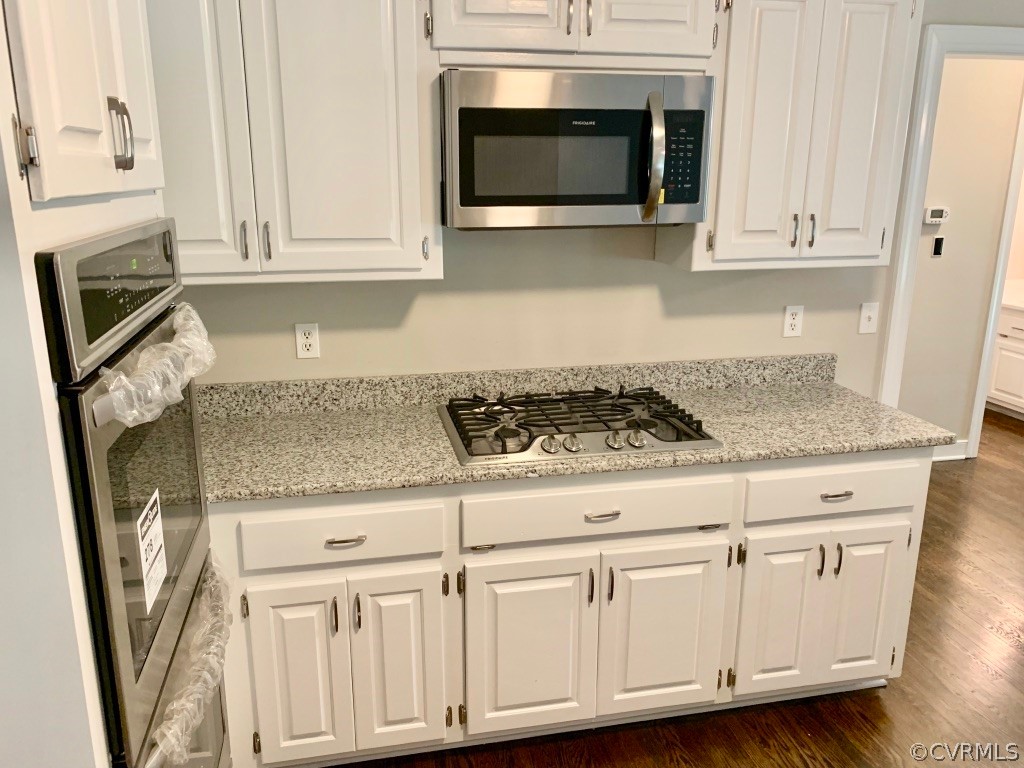 8301 Cattail Road Chesterfield, VA 23838 - Photo 15 of 31 a kitchen with granite countertop white cabinets appliances and a sink