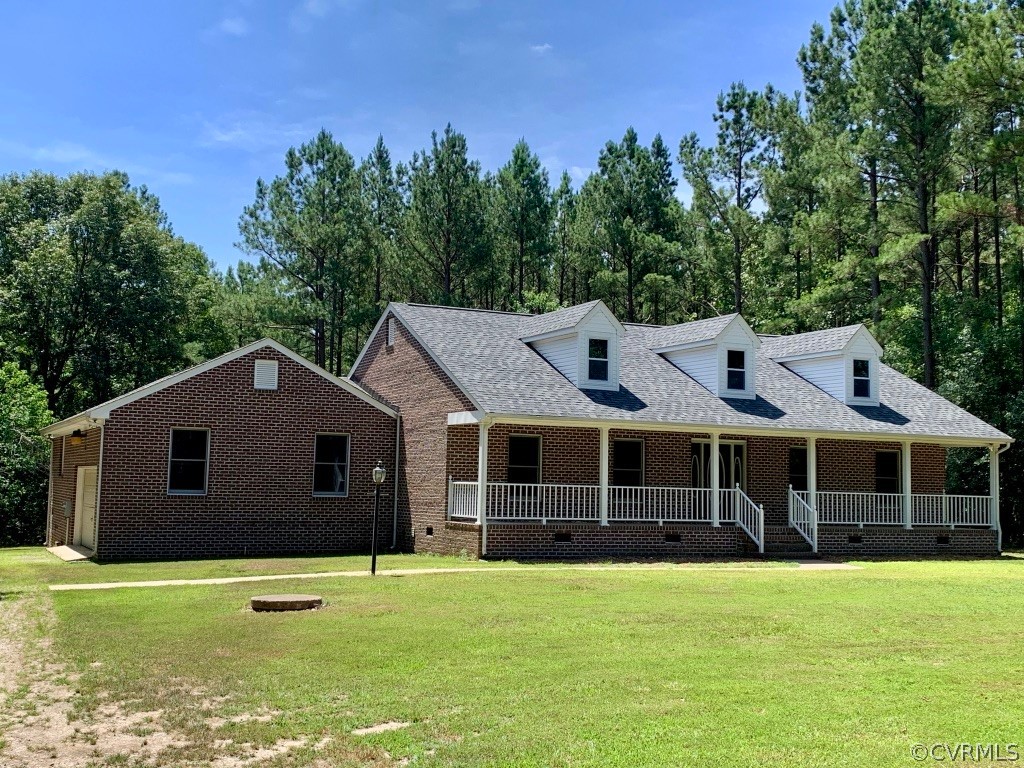 8301 Cattail Road Chesterfield, VA 23838 - Photo 2 of 31 a front view of a house with a garden and trees