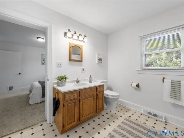 a bathroom with a sink a toilet and a mirror