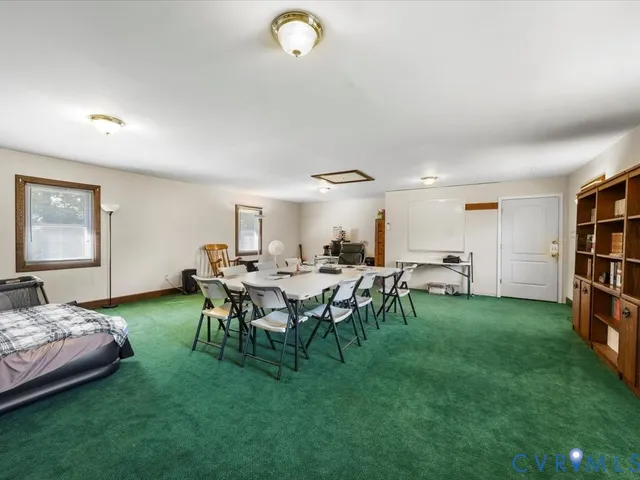 a view of a livingroom with furniture and lounge chair