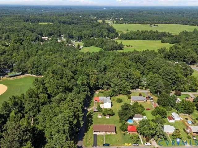 an aerial view of a houses with a yard